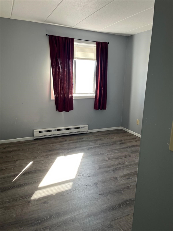 10 Main Street, Unit 508 Framingham, MA 01702 - Photo 4 of 11 a view of a livingroom with wooden floor and window