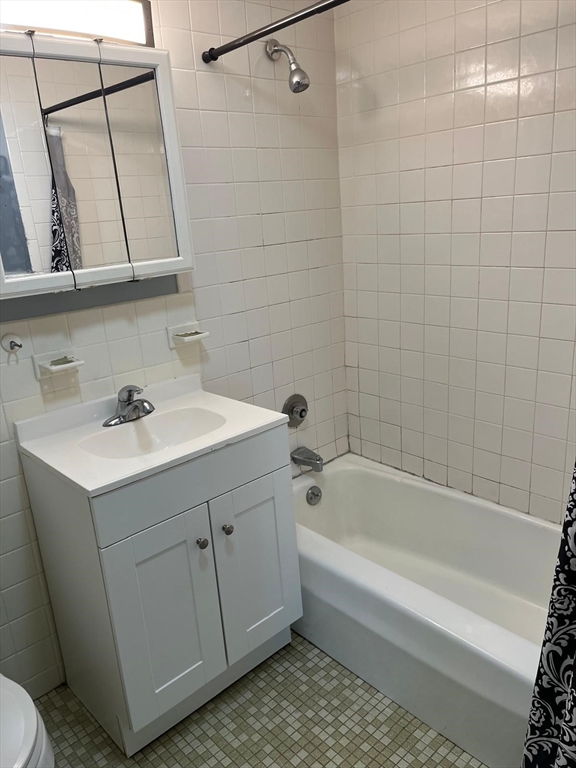 10 Main Street, Unit 508 Framingham, MA 01702 - Photo 8 of 11 a bathroom with a sink a toilet and bathtub