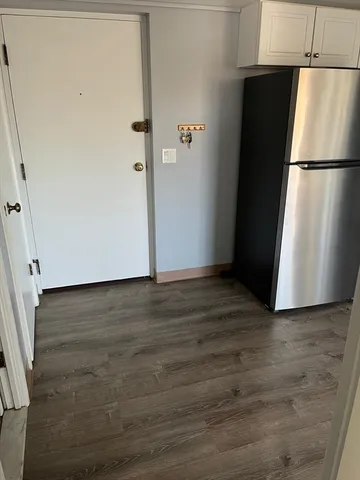 a kitchen with granite countertop white cabinets and white stainless steel appliances