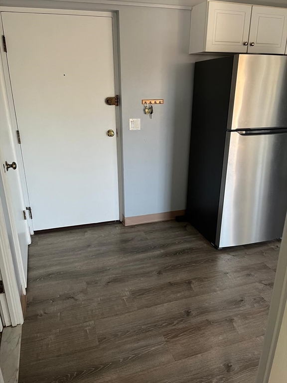 10 Main Street, Unit 508 Framingham, MA 01702 - Photo 10 of 11 a view of a refrigerator in kitchen and an empty room