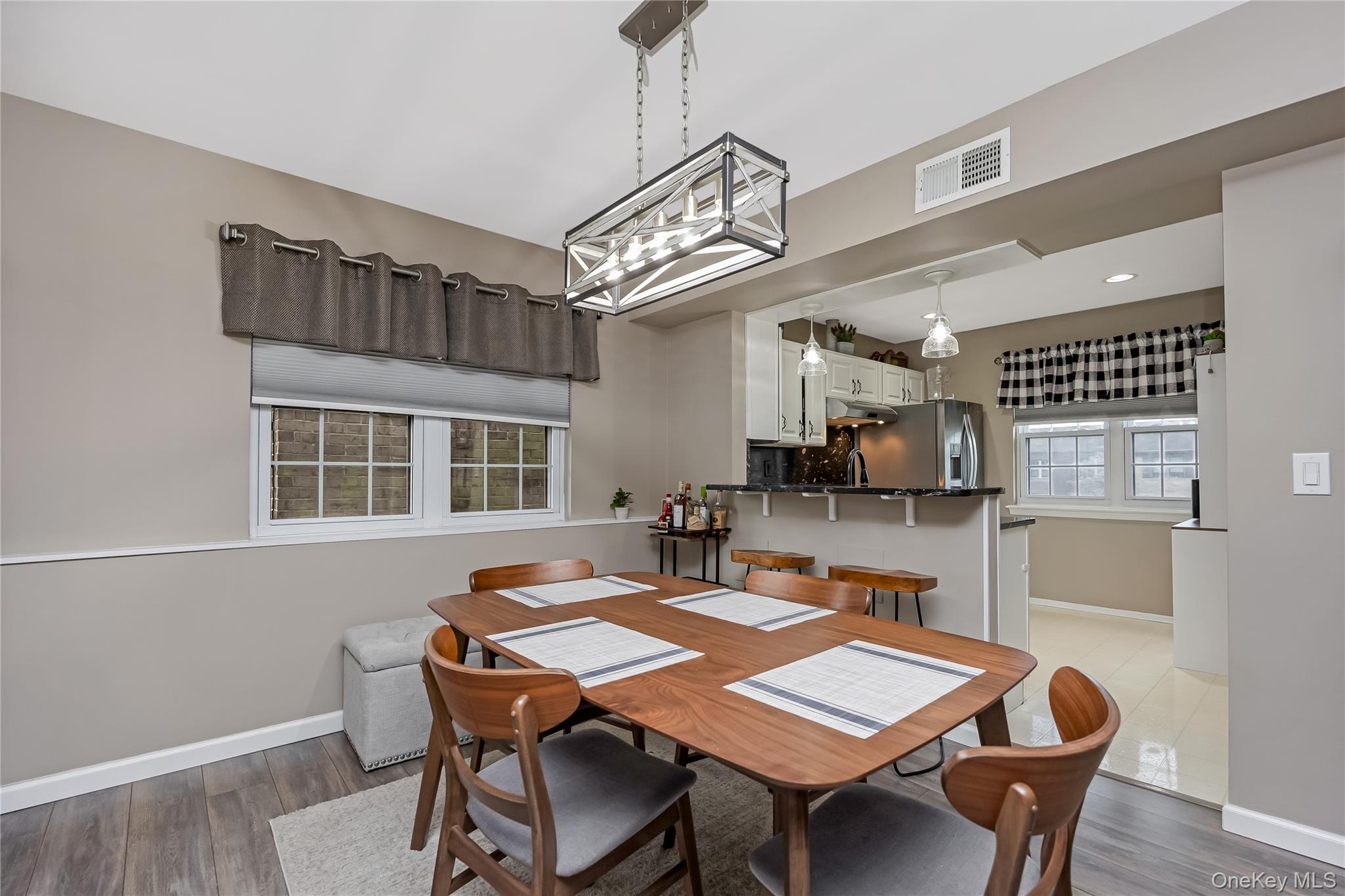 140 Mariners Way Copiague, NY 11726 - Photo 13 of 26 a view of a dining room with furniture and wooden floor