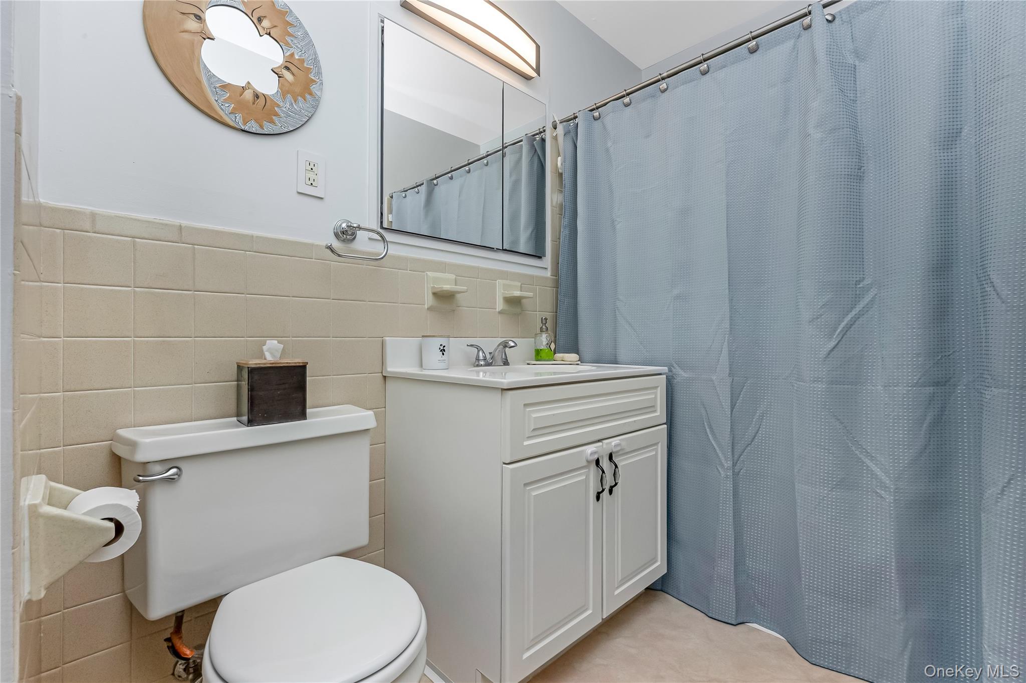 140 Mariners Way Copiague, NY 11726 - Photo 15 of 26 a bathroom with a sink a toilet and a mirror