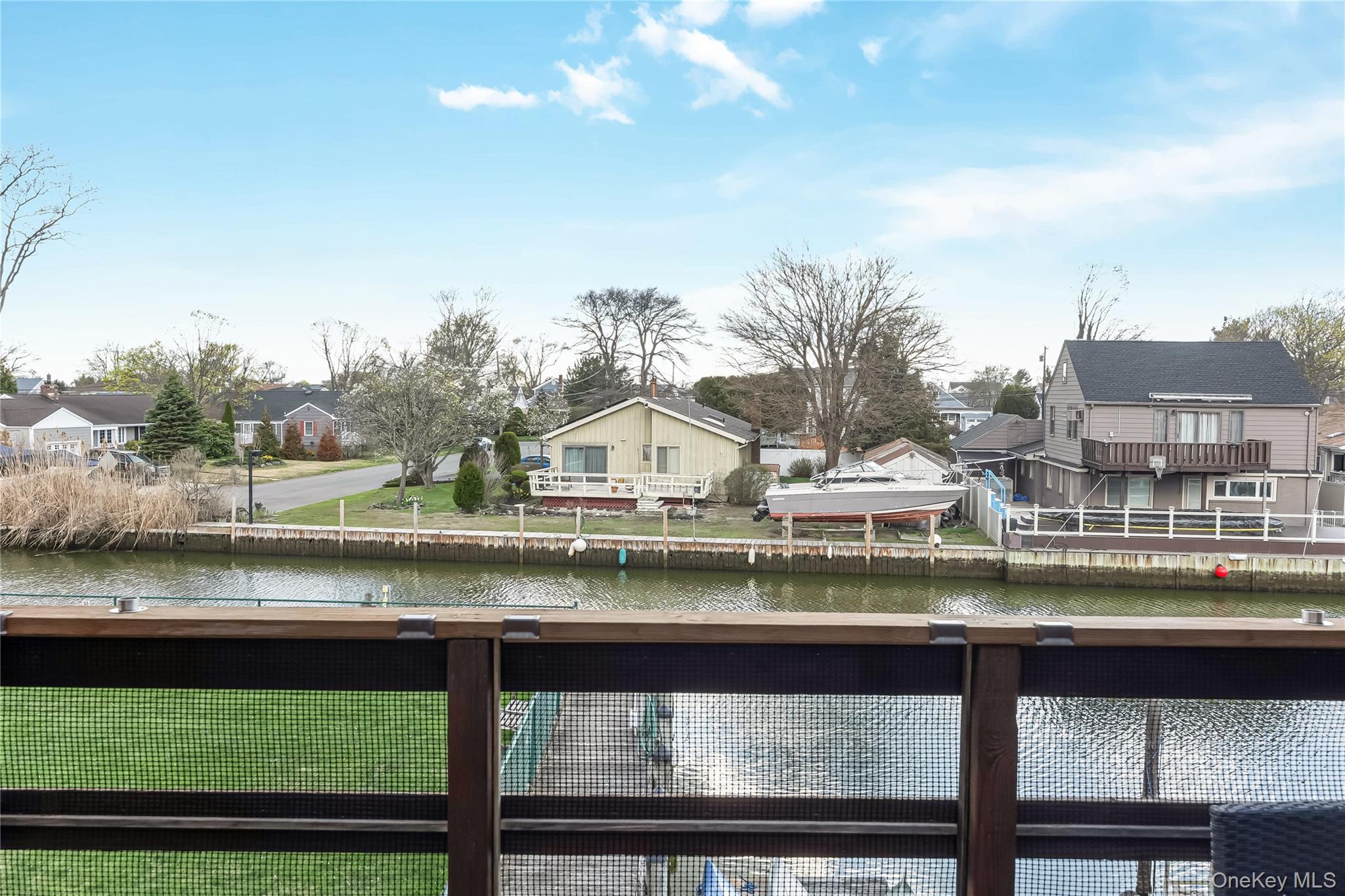 140 Mariners Way Copiague, NY 11726 - Photo 17 of 26 a view of a lake with houses