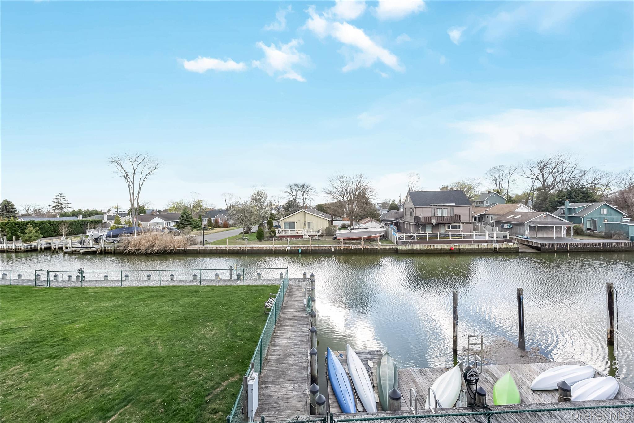 140 Mariners Way Copiague, NY 11726 - Photo 20 of 26 a view of a lake with a table and chairs