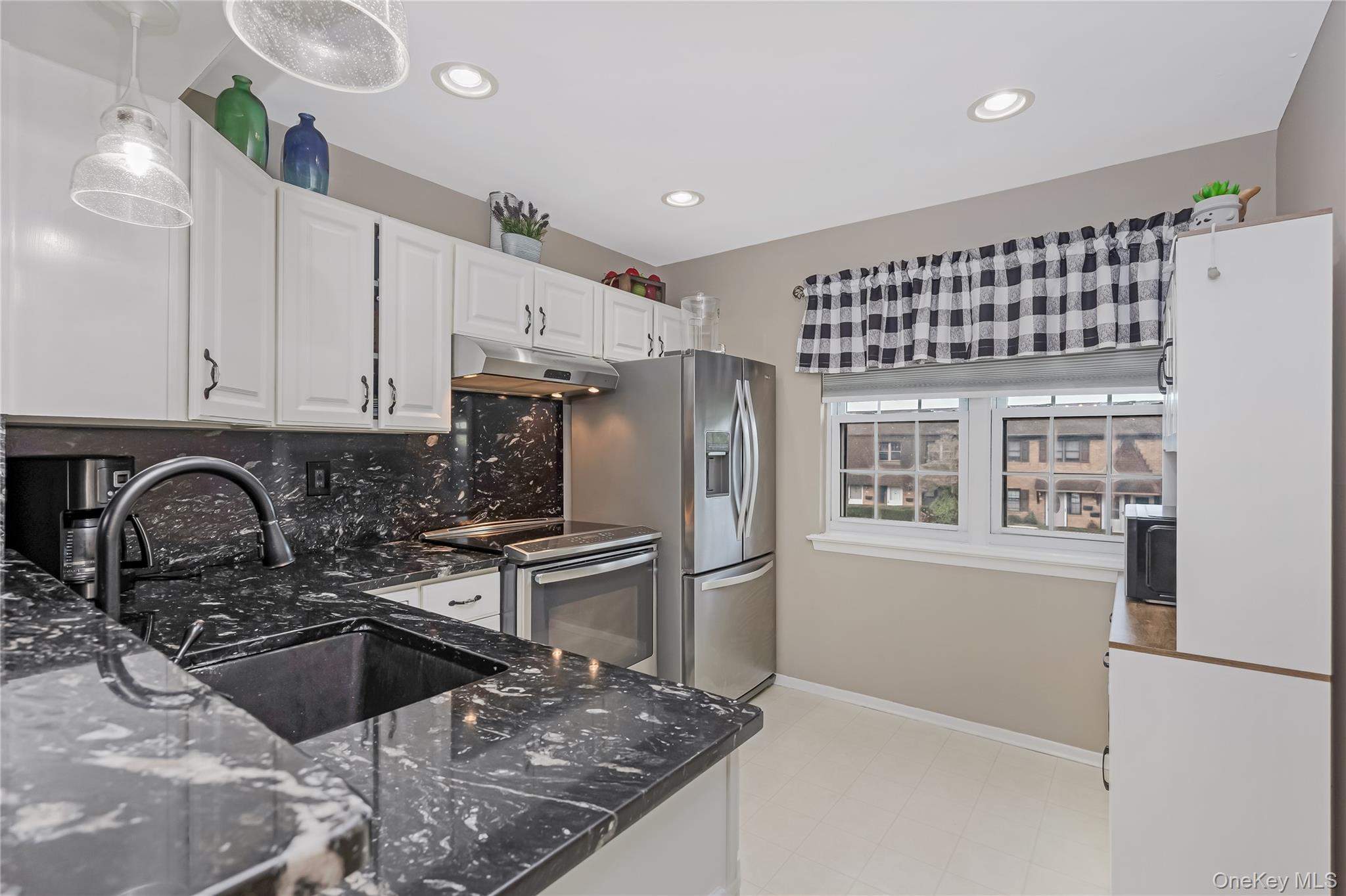 140 Mariners Way Copiague, NY 11726 - Photo 2 of 26 a kitchen with a sink cabinets and stainless steel appliances