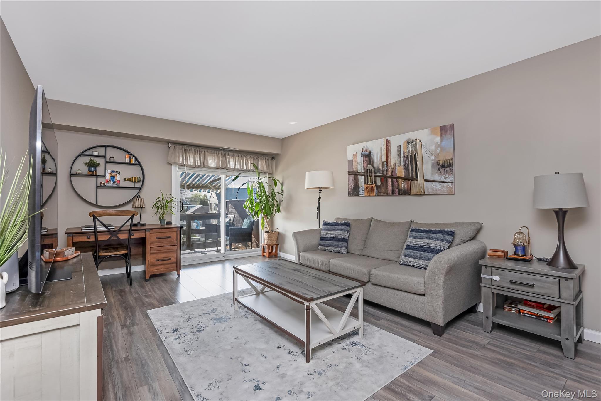 140 Mariners Way Copiague, NY 11726 - Photo 7 of 26 a living room with furniture a rug and a window