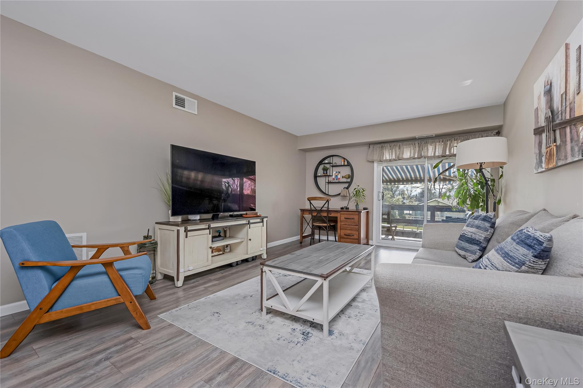 140 Mariners Way Copiague, NY 11726 - Photo 9 of 26 a living room with furniture and a flat screen tv