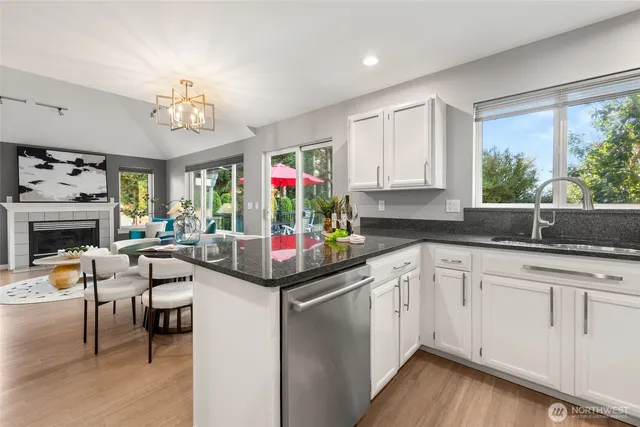 a kitchen with stainless steel appliances granite countertop a stove cabinets and wooden floor