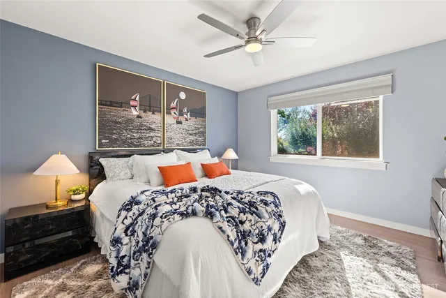 a bed sitting in a bedroom next to a window