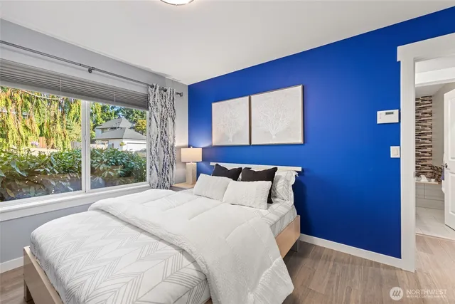 a large bed sitting in a bedroom next to a window