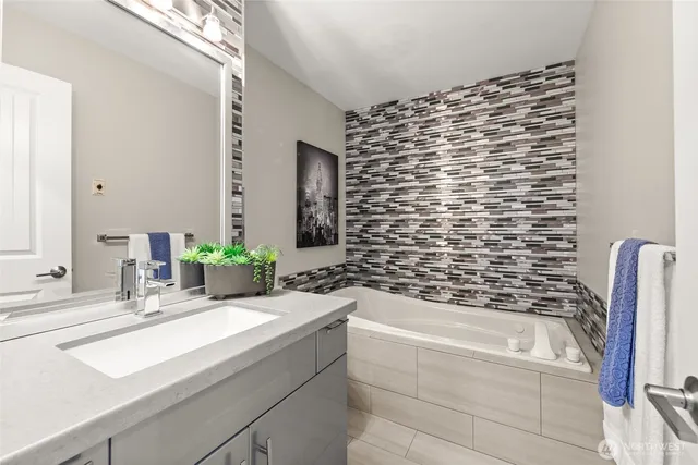 a bathroom with a bathtub and a sink