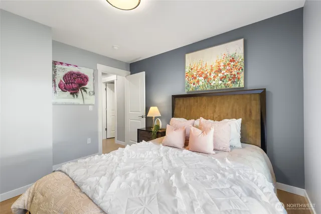 a bedroom with a bed and a painting on the wall