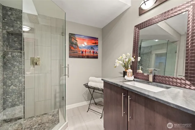 a bathroom with a sink a mirror and a shower