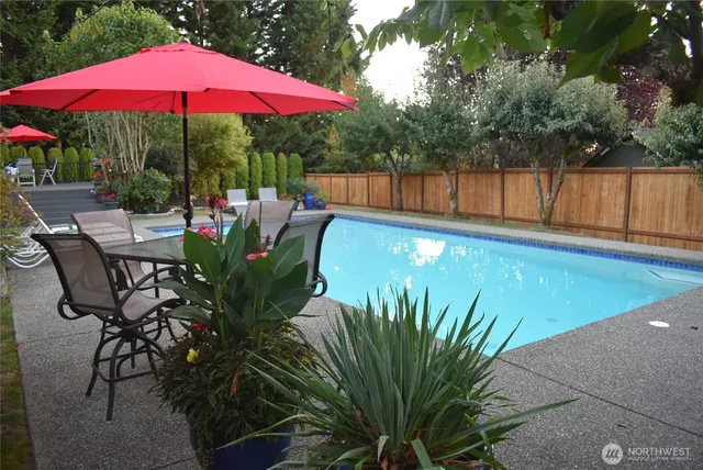 a view of a swimming pool with chairs in patio
