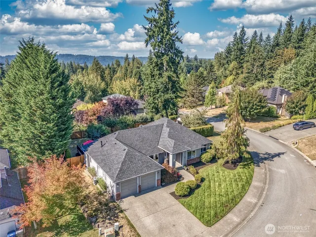 a aerial view of a house with a yard and garden