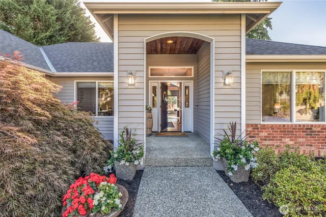 a front view of a house with a garden