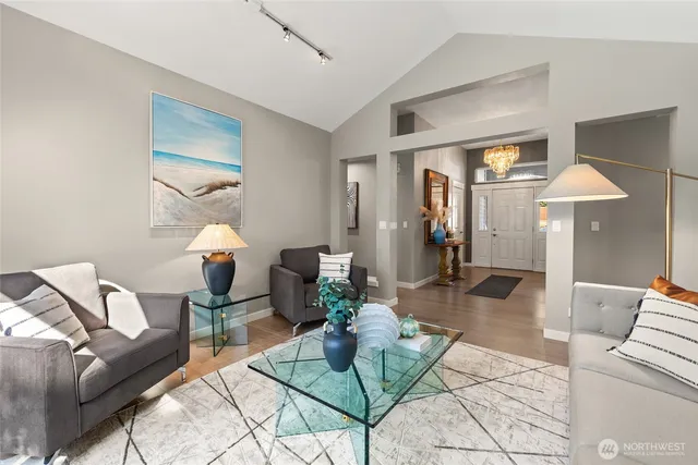 a living room with furniture a dining table and a lamp