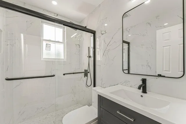 a bathroom with a sink toilet and shower