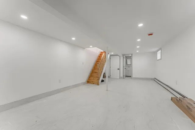 a view of an empty room with staircase