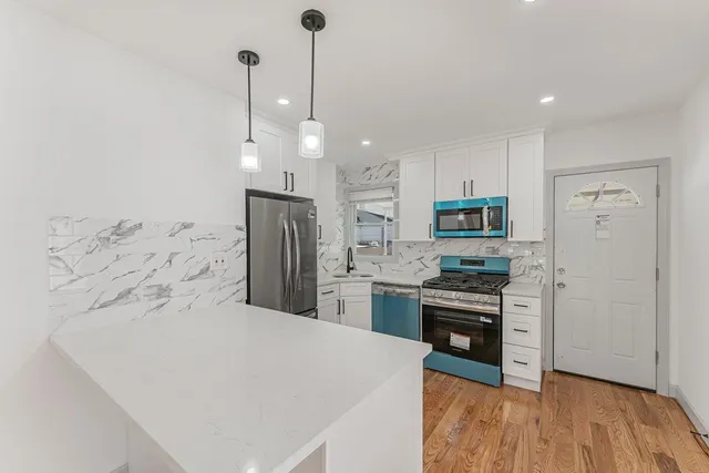 a kitchen with stainless steel appliances a refrigerator sink and stove