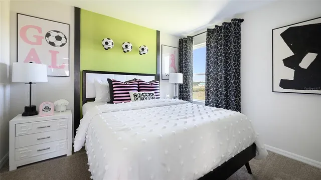 a bedroom with a bed and a painting on the wall