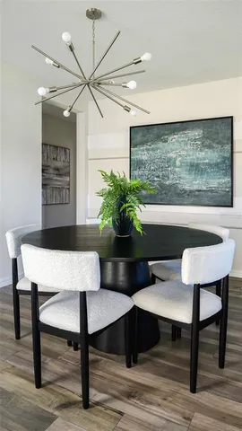 a view of a room with a table and chairs