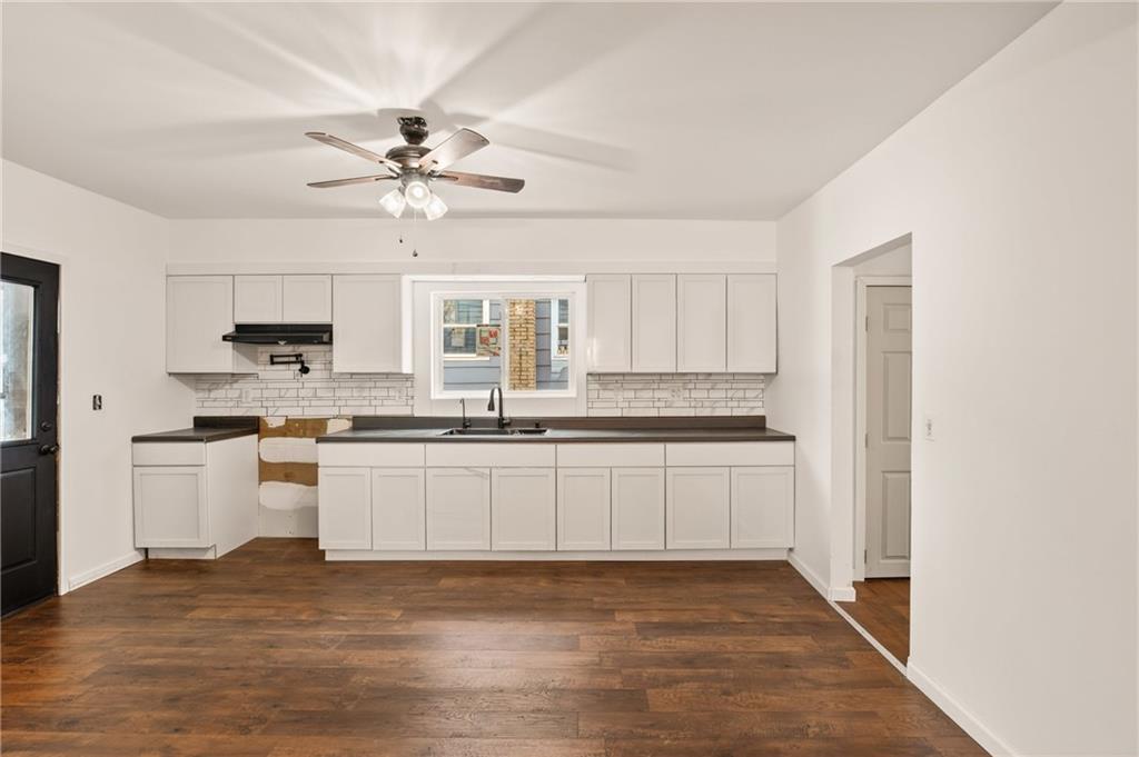 403 9th Street Windber, PA 15963 - Photo 13 of 34 a kitchen with stainless steel appliances granite countertop a sink cabinets and wooden floor