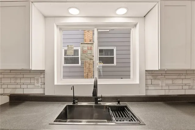 a kitchen with a sink and a window