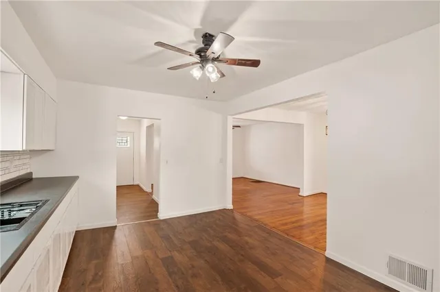 a view of kitchen with sink and wooden floor