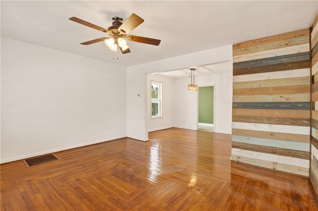 403 9th Street Windber, PA 15963 - Photo 5 of 34 a view of an empty room with wooden floor and a ceiling fan