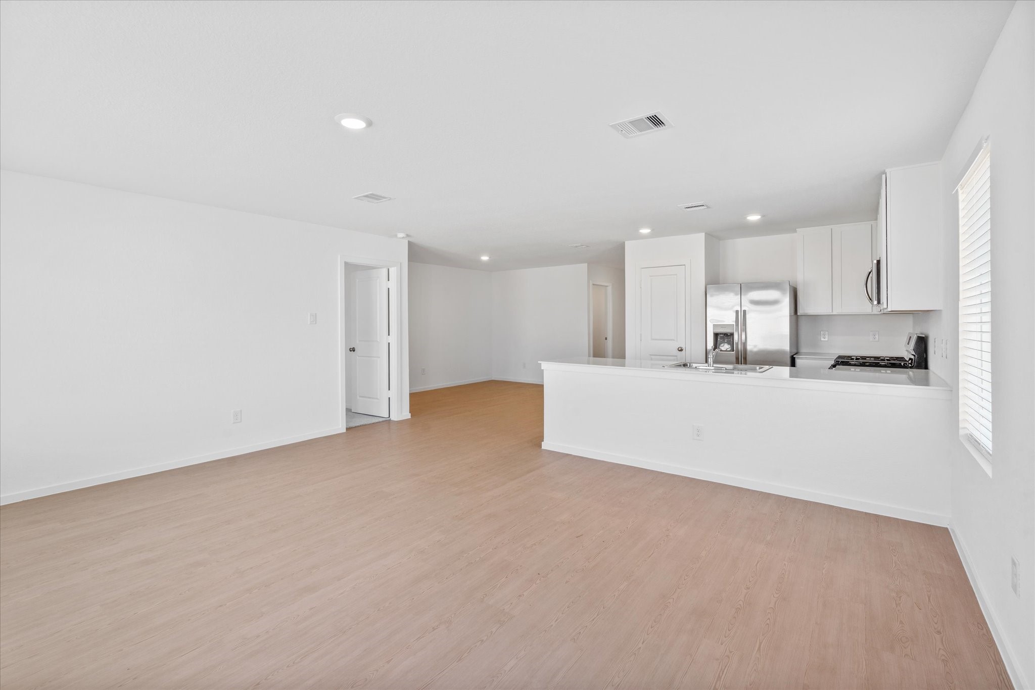 28922 Rustic Windmill Way Hockley, TX 77447 - Photo 15 of 24 a view of a kitchen with kitchen island and stainless steel appliances