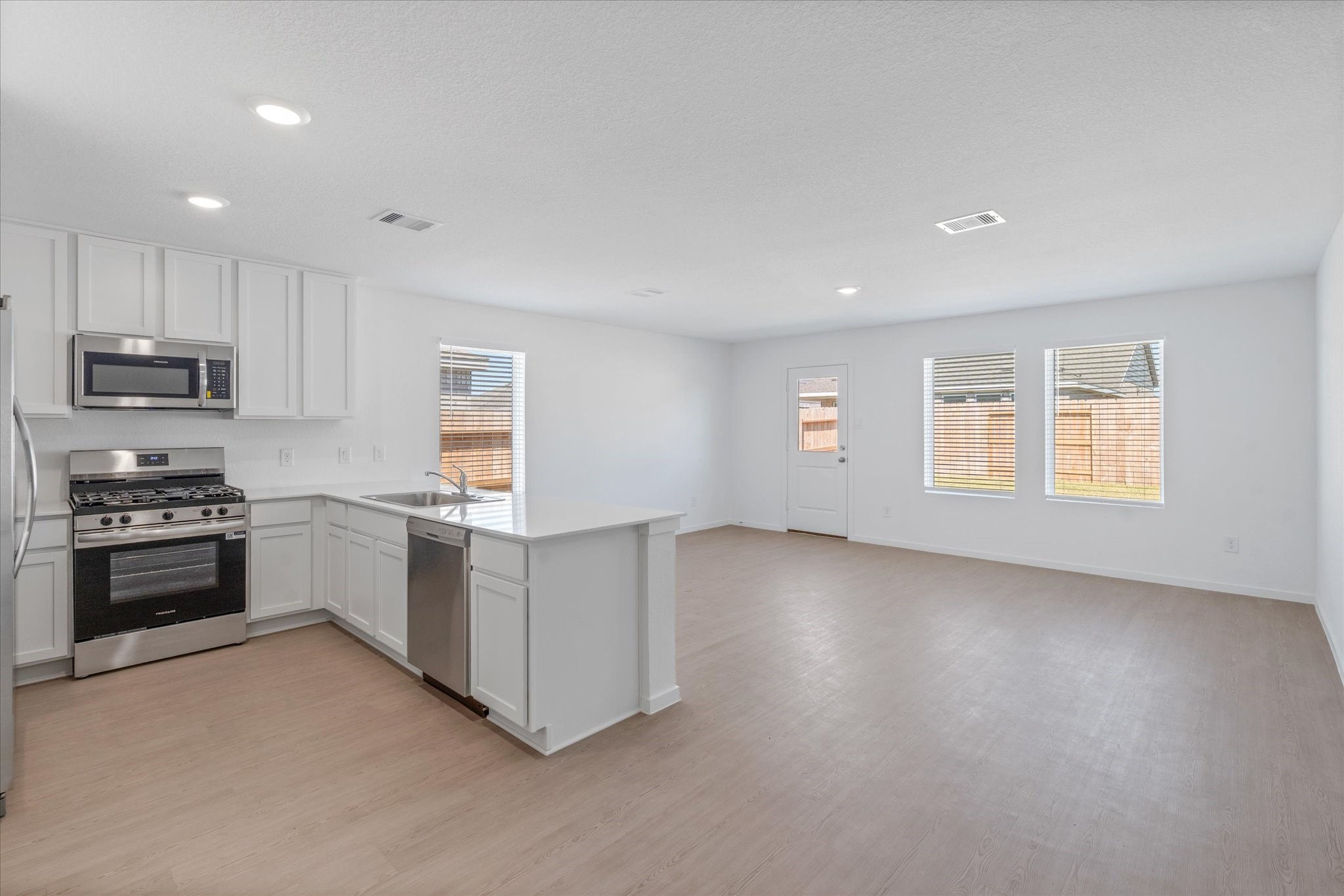 28922 Rustic Windmill Way Hockley, TX 77447 - Photo 16 of 24 a kitchen with a white cabinets and appliances
