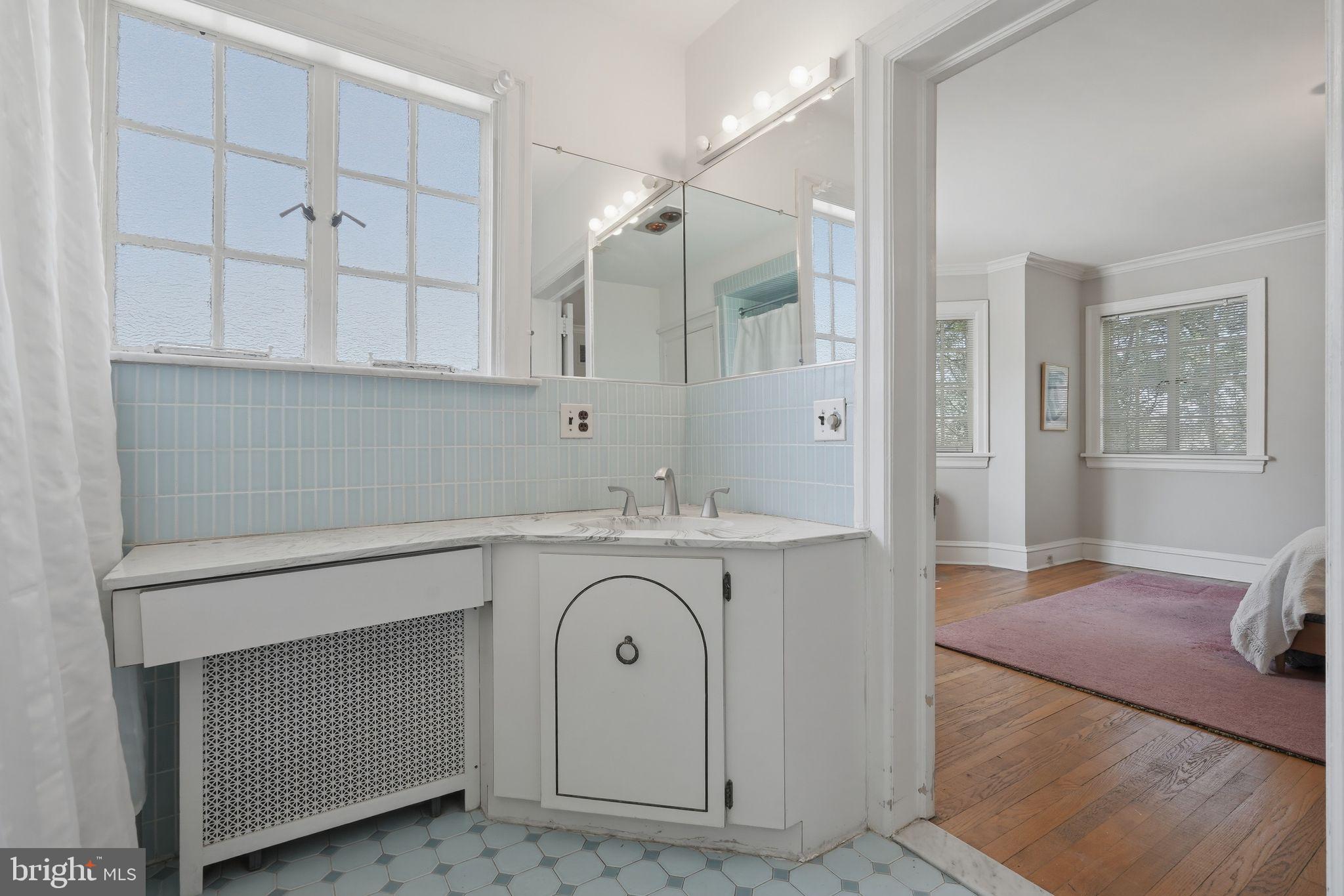 408 Upland Road Elkins Park, PA 19027 - Photo 20 of 41 a spacious bathroom with a granite countertop sink mirror and vanity