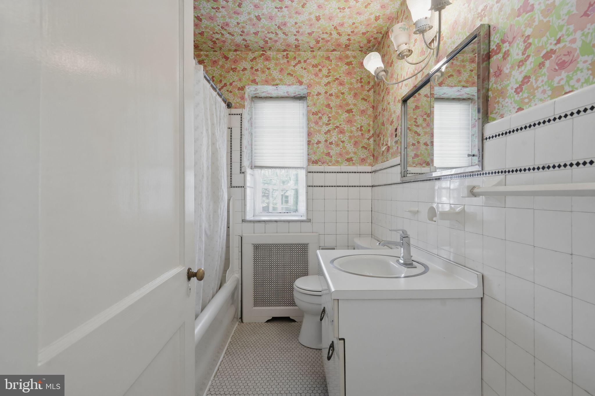 408 Upland Road Elkins Park, PA 19027 - Photo 28 of 41 a bathroom with a sink and mirror with bathtub