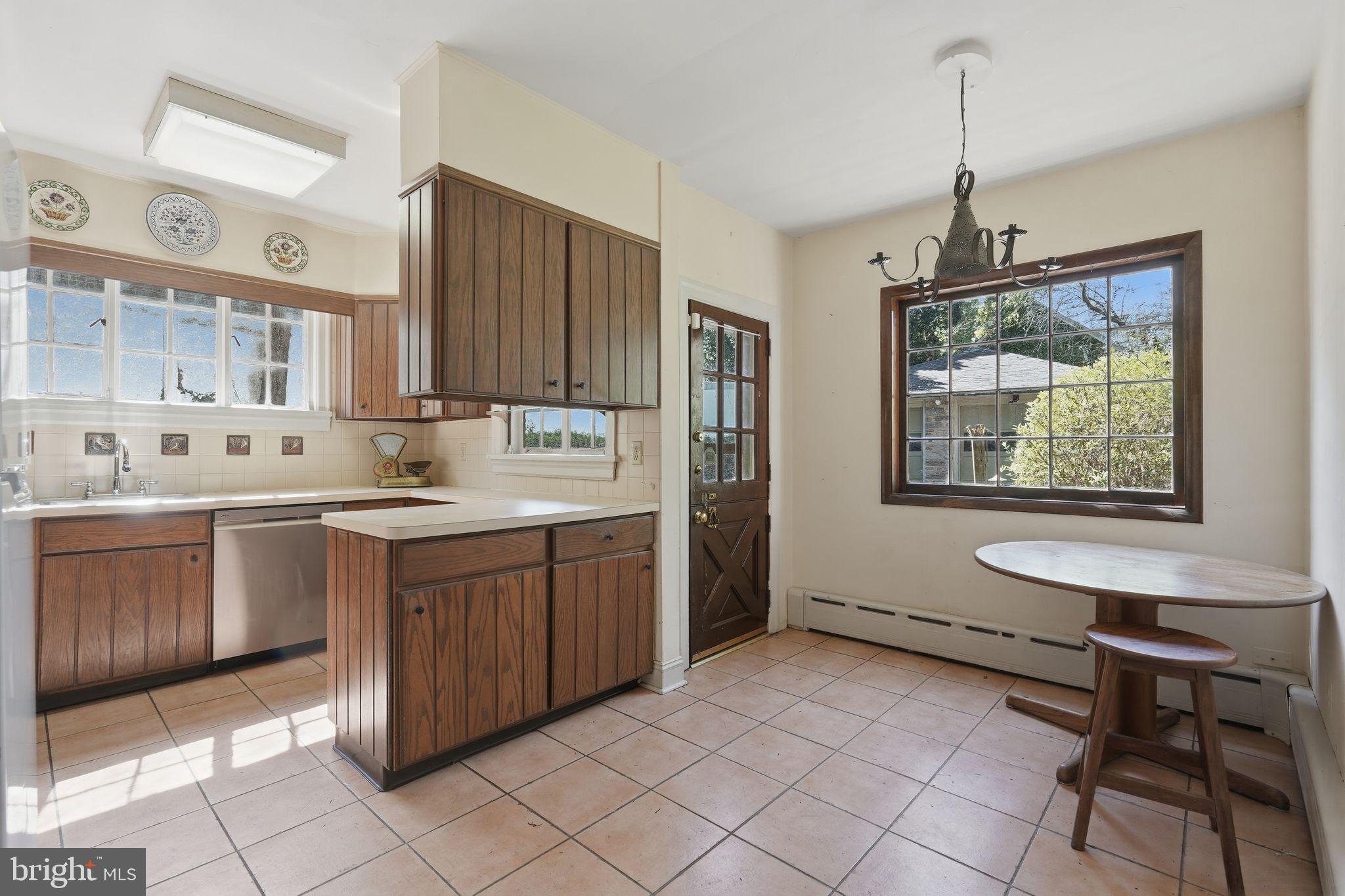 408 Upland Road Elkins Park, PA 19027 - Photo 8 of 41 a kitchen with a sink window and cabinets