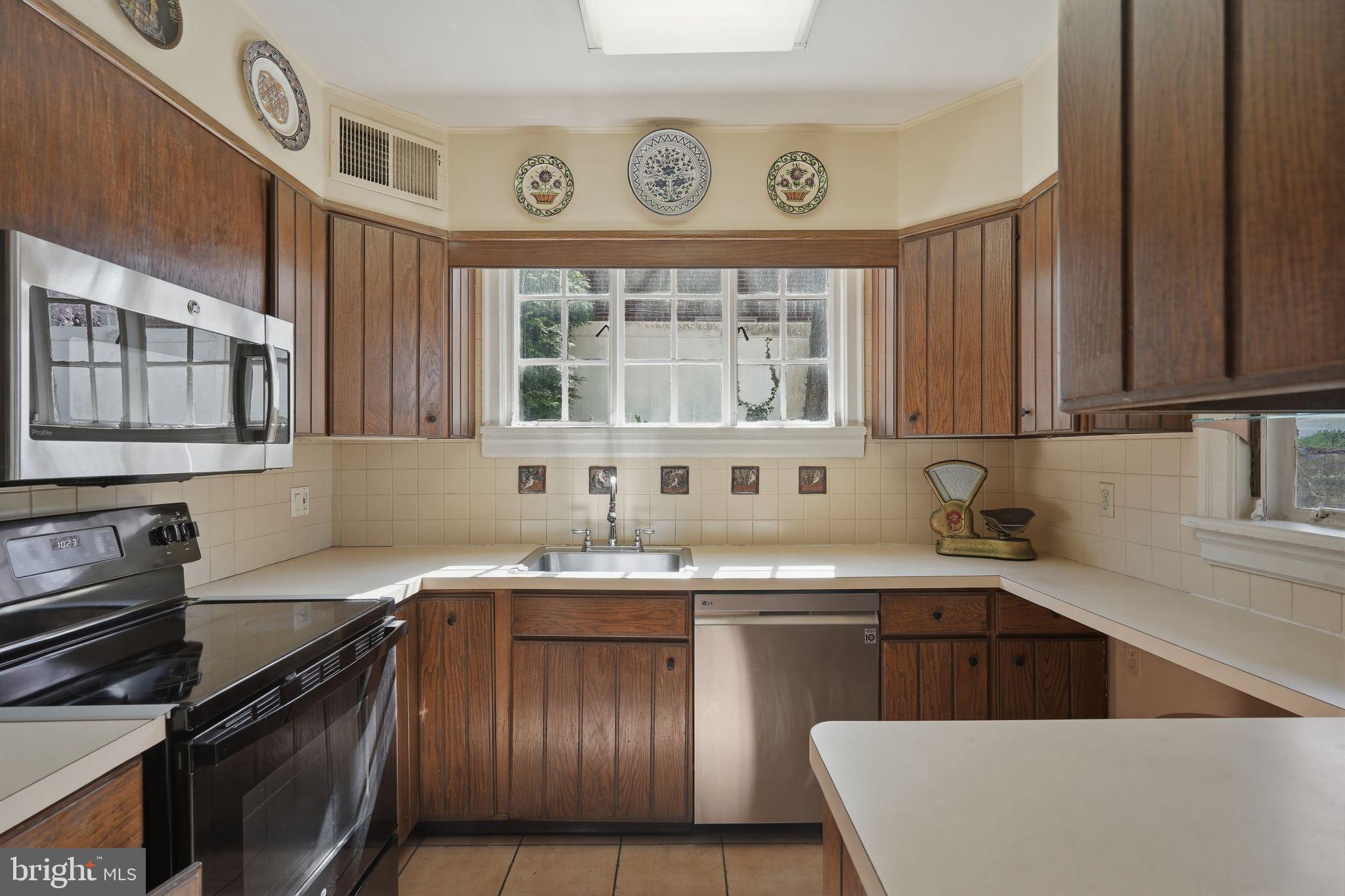 408 Upland Road Elkins Park, PA 19027 - Photo 9 of 41 a kitchen with stainless steel appliances granite countertop a sink stove and cabinets
