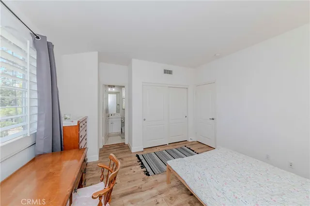 a view of a garden with a chair and table in the balcony