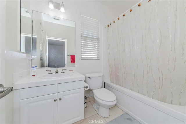 a front view of a house with a yard and potted plants