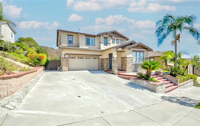 a view of a house with backyard and sitting area