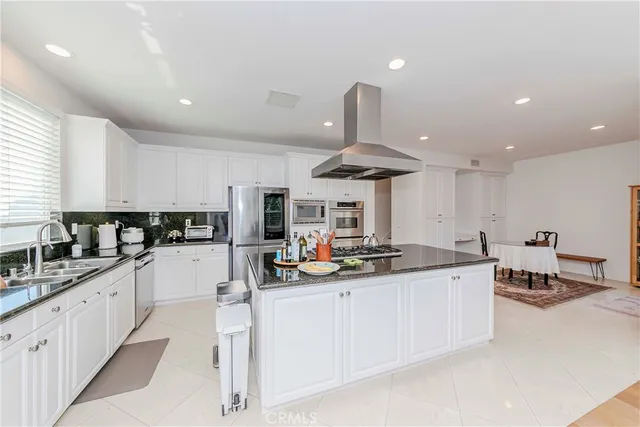 a spacious bedroom with a bed and a flat screen tv