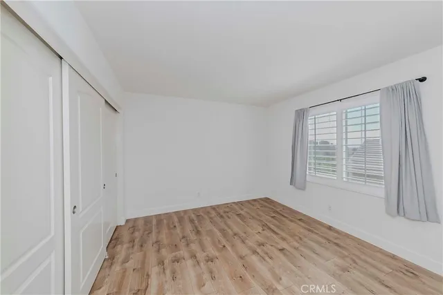 a kitchen with stainless steel appliances a sink a stove a refrigerator cabinets and living room view