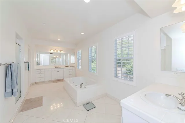 a kitchen with stainless steel appliances granite countertop a sink stove and white cabinets