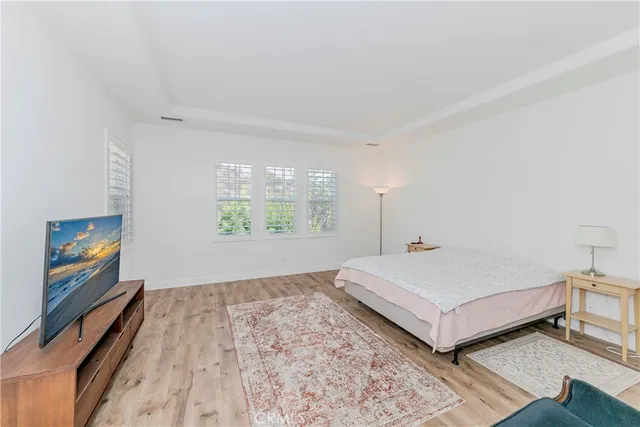 a bedroom with bed and a window