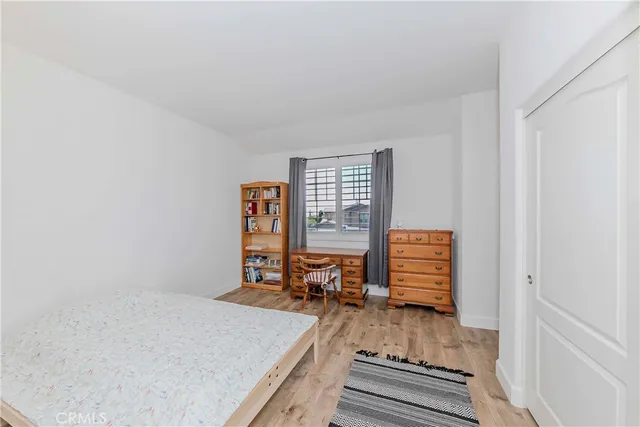 a bedroom with furniture and a window