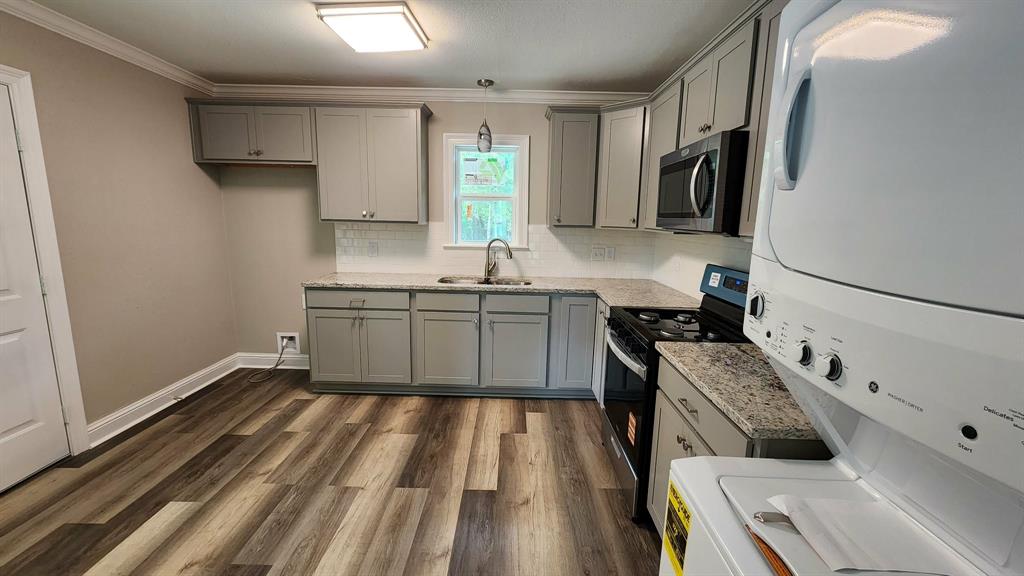 205 Roy Street Minden, LA 71055 - Photo 2 of 8 a kitchen with stainless steel appliances granite countertop a sink stove and refrigerator