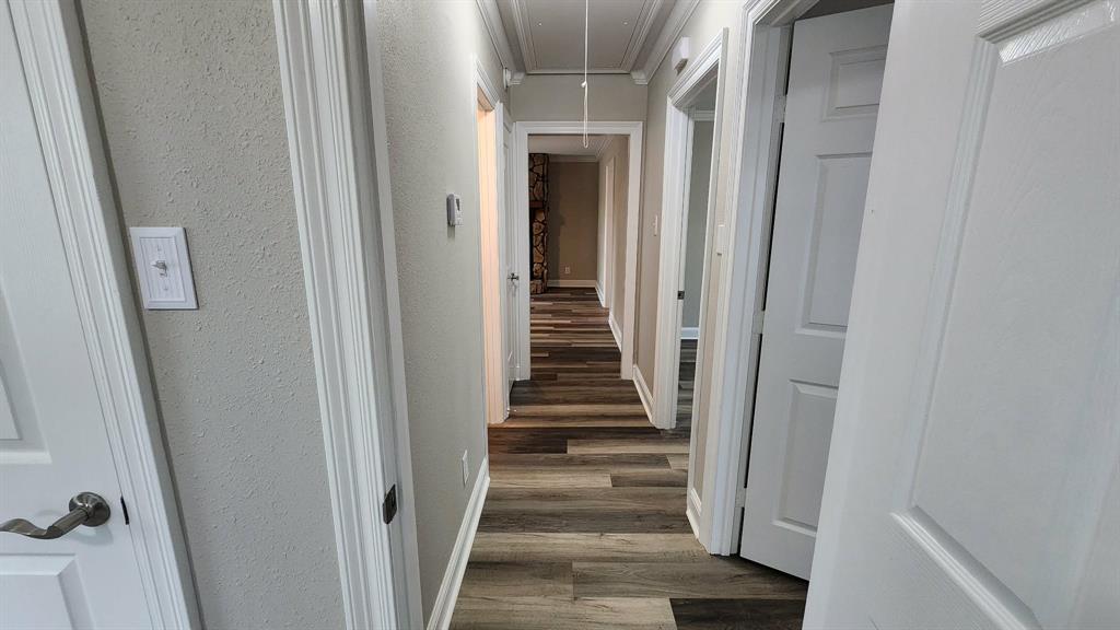 205 Roy Street Minden, LA 71055 - Photo 4 of 8 a view of a hallway with wooden floor and entryway
