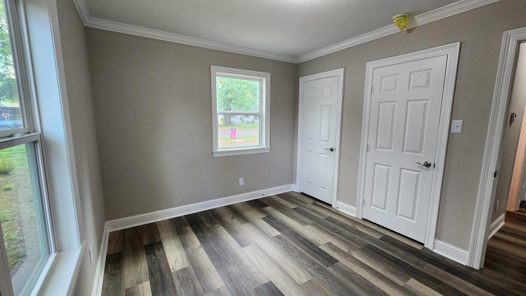 205 Roy Street Minden, LA 71055 - Photo 5 of 8 a view of an empty room with wooden floor and a window