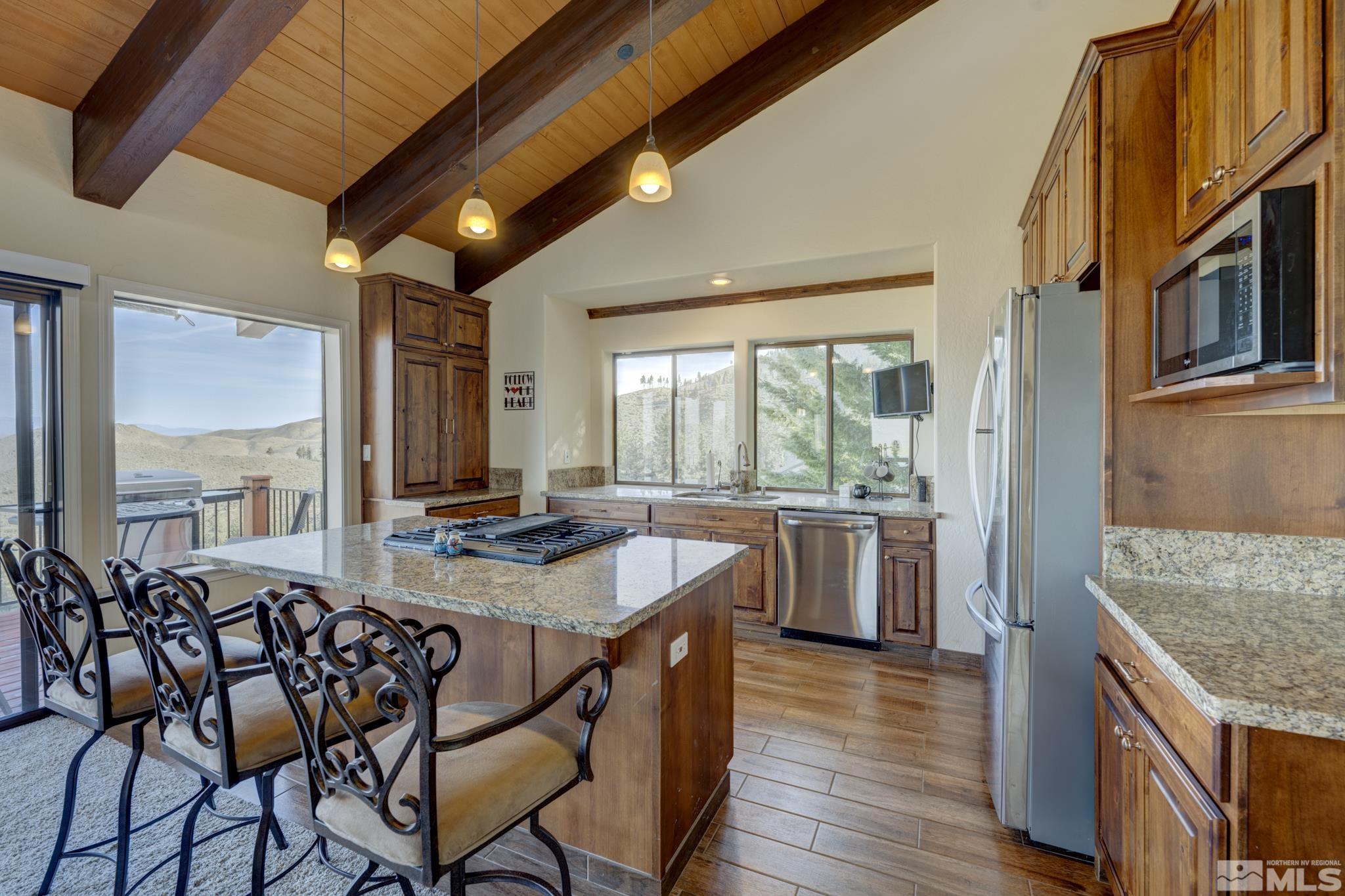 3760 Paradise View Carson City, NV 89703 - Photo 11 of 40 a dining hall with stainless steel appliances granite countertop a stove and a refrigerator