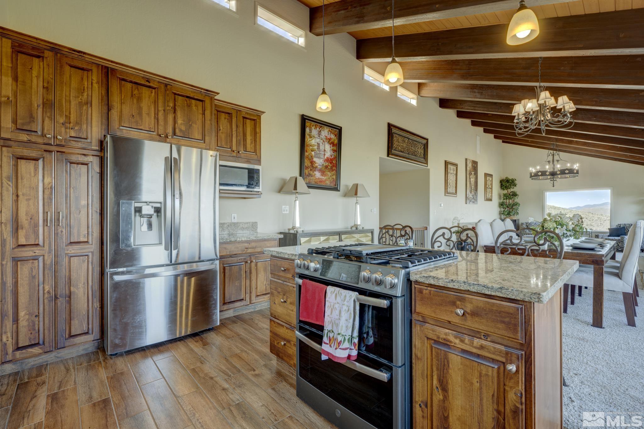 3760 Paradise View Carson City, NV 89703 - Photo 13 of 40 a kitchen with stainless steel appliances granite countertop a stove and a refrigerator