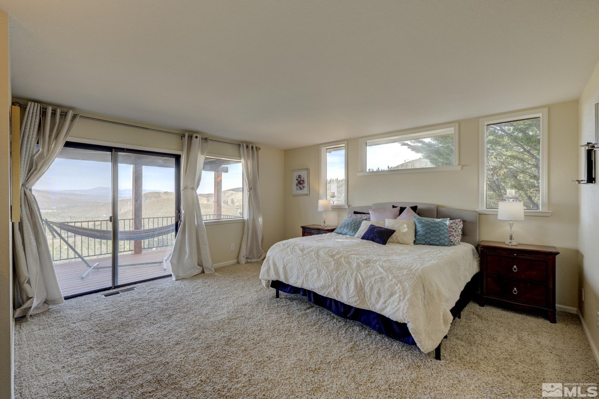 3760 Paradise View Carson City, NV 89703 - Photo 15 of 40 a bedroom with a large bed and a large window